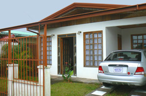 The Tilaran home has iron fencing and a carport.